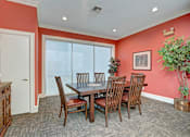 Thumbnail 7 of 48 - A dining room with a table and chairs.