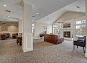 Thumbnail 5 of 48 - A large, well-lit living room with a fireplace and comfortable seating.