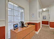 Thumbnail 10 of 48 - A room with a brown desk and a framed picture on it.
