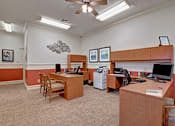 Thumbnail 9 of 48 - A room with two desks and chairs, one of which has a sign that says "Learning".