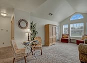Thumbnail 14 of 48 - A living room with a glass table and chairs.