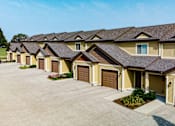 Thumbnail 54 of 60 - A row of houses with brown garage doors.