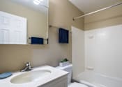 Thumbnail 26 of 27 - A bathroom with a white tub and sink.
