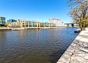 Thumbnail 62 of 64 - a body of water with buildings on the side of it