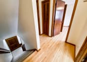 Thumbnail 25 of 27 - a living room and hallway with wood flooring and wooden doors