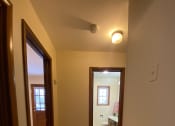 Thumbnail 20 of 27 - the view from the hallway looking into the living room and the bathroom