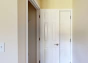 Thumbnail 38 of 48 - A white door is in a room with yellow walls.