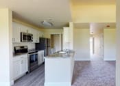 Thumbnail 43 of 48 - A kitchen with white cabinets and a black countertop.