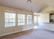 Thumbnail 37 of 48 - A spacious room with a carpeted floor and large windows.