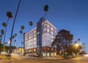 Thumbnail 1 of 24 - Exterior Twilight at Miles at Harvard, Los Angeles, CA, 90020