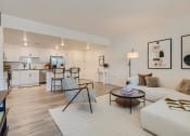 Thumbnail 30 of 69 - a living room with a white couch and two chairs at The Venue at Orange Apartments, Redlands, California