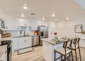 Thumbnail 39 of 69 - a kitchen with white cabinetry and stainless steel appliances