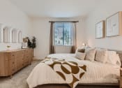 Thumbnail 53 of 69 - a bedroom with a bed and dresser in a 555 waverly unit