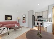 Thumbnail 5 of 23 - Spacious living room in Mar Vista apartment with open concept leading to modern kitchen and dining area. Large windows allow for gorgeous natural lighting and plank flooring