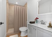 Thumbnail 11 of 23 - Bathroom in Mar Vista Apartment home with plank flooring, spacious shower, and modern vanity with plenty of cabinet storage.