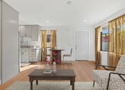 Thumbnail 8 of 23 - Living room in Mar Vista apartment with plank flooring and a lot of windows allowing for gorgeous natural lighting. Open floorplan leading to dining area and modern kitchen