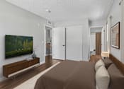 Thumbnail 17 of 30 - Spacious bedroom in 1 bed 1 bath Azusa Gardens apartment home with wood style plank flooring, multiple windows for natural lighting and views, and a private bathroom