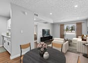 Thumbnail 13 of 30 - View of spacious living area from dining nook in Azusa Gardens 1 bed 1 bath apartment home with wood-style plank flooring and view of large window allowing for gorgeous natural light to filter throughout the space