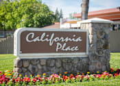 Thumbnail 1 of 37 - Stone monument sign at the entrance to California Place apartments