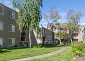 Thumbnail 15 of 37 - Charming exterior of California Place apartments with grass lined walkways and lush greenery, providing a beautiful and serene living experience!