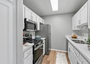 Thumbnail 19 of 30 - Updated kitchen in Azusa Gardens 2 bed 1 Bath apartment home with wood-style plank flooring, white shaker cabinets, quartz countertops, stainless appliances and brushed nickel finishes.