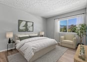 Thumbnail 23 of 30 - Spacious primary bedroom in Azusa Gardens 2 Bed 1 Bath apartment home with wood-style plank flooring, large windows, and a oversized closet.