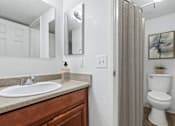 Thumbnail 24 of 31 - Bathroom in 2 Bed 1 Bath Option B Bent Tree Apartment with wood-style plank flooring, plenty of cabinet space, a large vanity mirror, and a shower/tub