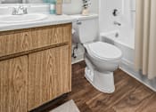 Thumbnail 29 of 31 - Bathroom 1 in 2 Bed 2 Bath Bent Tree Apartment home with wood plank-style flooring, a large vanity mirror and a shower/tub