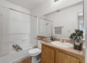 Thumbnail 32 of 37 - A white bathroom with a toilet, sink, and shower.
