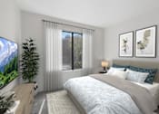 Thumbnail 36 of 37 - Bedroom in 1 Bed 1 Bath A California Place floor plan with plush carpeted flooring and a large window allowing for gorgeous natural light to filter through the room and views of the properties' lush greenery.