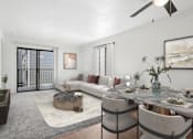 Thumbnail 19 of 37 - Spacious living area in 2 Bedroom California place apartment home with plush carpeted flooring and large sliding doors leading to private patio/balcony. Open concept floor plan layout leads to the dining nook with wood-style plank flooring and a ceiling fan