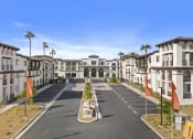 Thumbnail 28 of 69 - an empty street in front of apartments with palm trees at The Venue at Orange Apartments, California