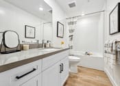 Thumbnail 58 of 69 - a white bathroom with a shower toilet and sink