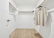 Thumbnail 66 of 69 - a spacious walk in closet with a white wall and a white closet door with a