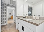 Thumbnail 59 of 69 - a large white bathroom with a sink and a mirror