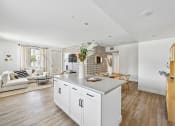 Thumbnail 43 of 69 - a kitchen with a large island and a living room