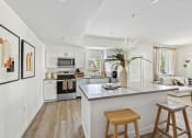 Thumbnail 41 of 69 - an open kitchen and living room with an island and stools