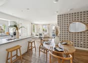 Thumbnail 45 of 69 - a living room with a kitchen and a dining table