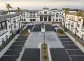 Thumbnail 27 of 69 - an aerial view of an empty parking lot in front of houses at The Venue at Orange Apartments, Redlands, CA, 92373