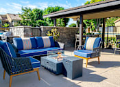 Thumbnail 20 of 36 - blue couches and chairs and a fire pit