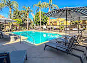 Thumbnail 18 of 36 - swimming pool with chair lounge and umbrella
