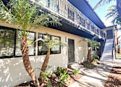 Thumbnail 3 of 23 - a house with a balcony and palm trees in front of it