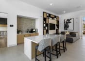 Thumbnail 6 of 69 - a kitchen and living room with a table and chairs at The Venue at Orange Apartments, Redlands, CA, 92373