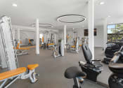Thumbnail 14 of 69 - a gym with cardio equipment and weights in a building at The Venue at Orange Apartments, Redlands