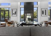 Thumbnail 1 of 69 - a living room with a couch and chairs and a fireplace at The Venue at Orange Apartments, Redlands, 92373