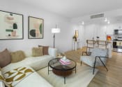 Thumbnail 31 of 69 - a living room with a couch and a coffee table at The Venue at Orange Apartments, Redlands, 92373