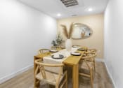 Thumbnail 51 of 69 - a dining room with a wooden table and chairs