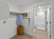 Thumbnail 65 of 69 - a bathroom with a closet and a shower and a basket on the floor