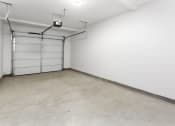 Thumbnail 69 of 69 - an empty room with a white wall and a garage door