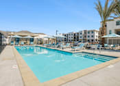 Thumbnail 7 of 38 - Resort style swimming pool with lounge chairs at Altitude Apartments, Moreno Valley, CA